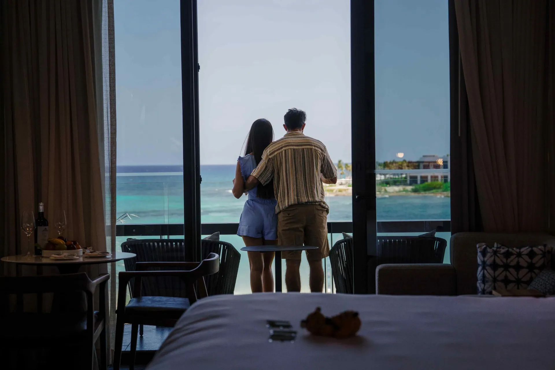 Couple on the balcony of a hotel room at Conrad Tulum Riviera Maya