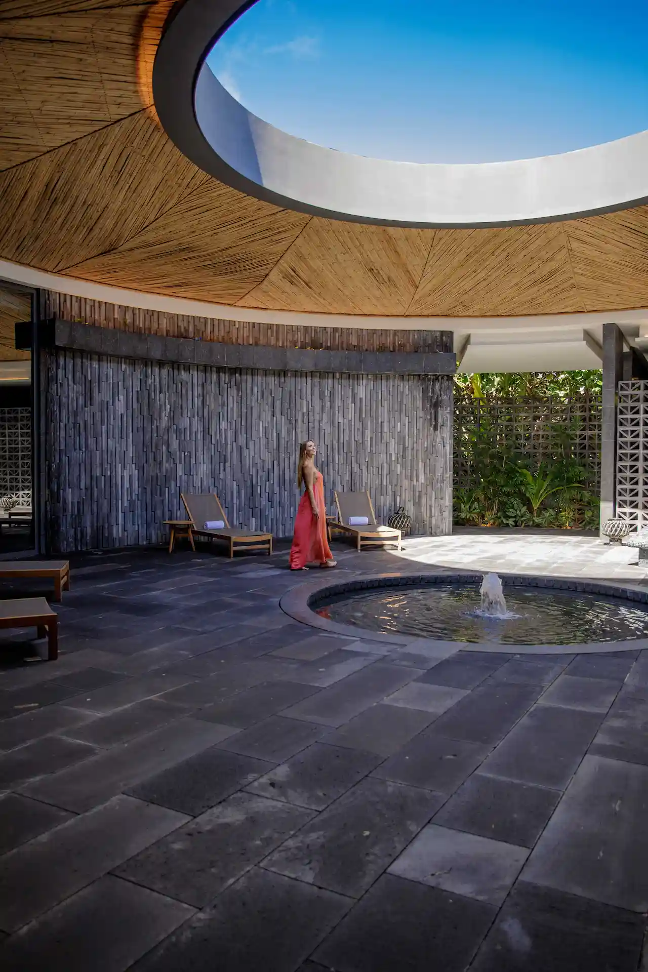 Woman walking through the spa area at Conrad Tulum Riviera Maya hotel