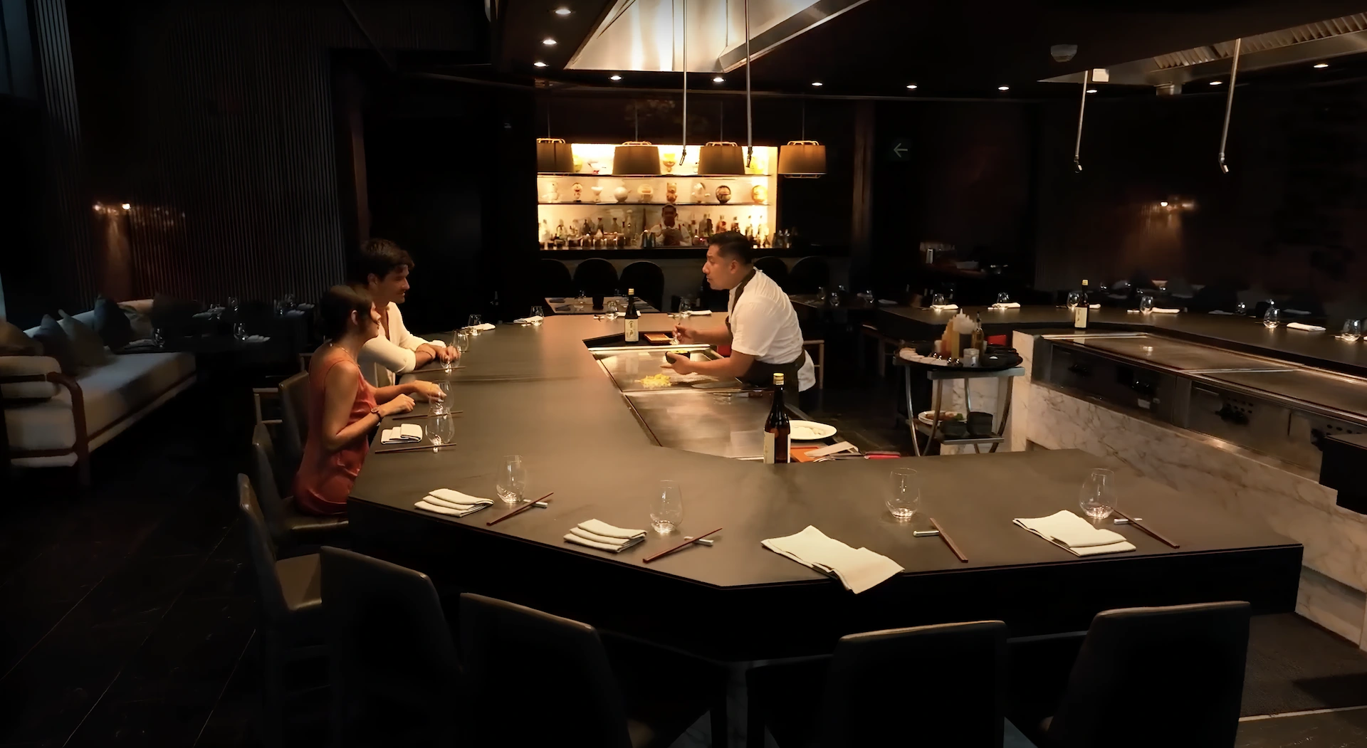 A chef prepares food for customers at the bar of the Conrad Tulum hotel restaurant