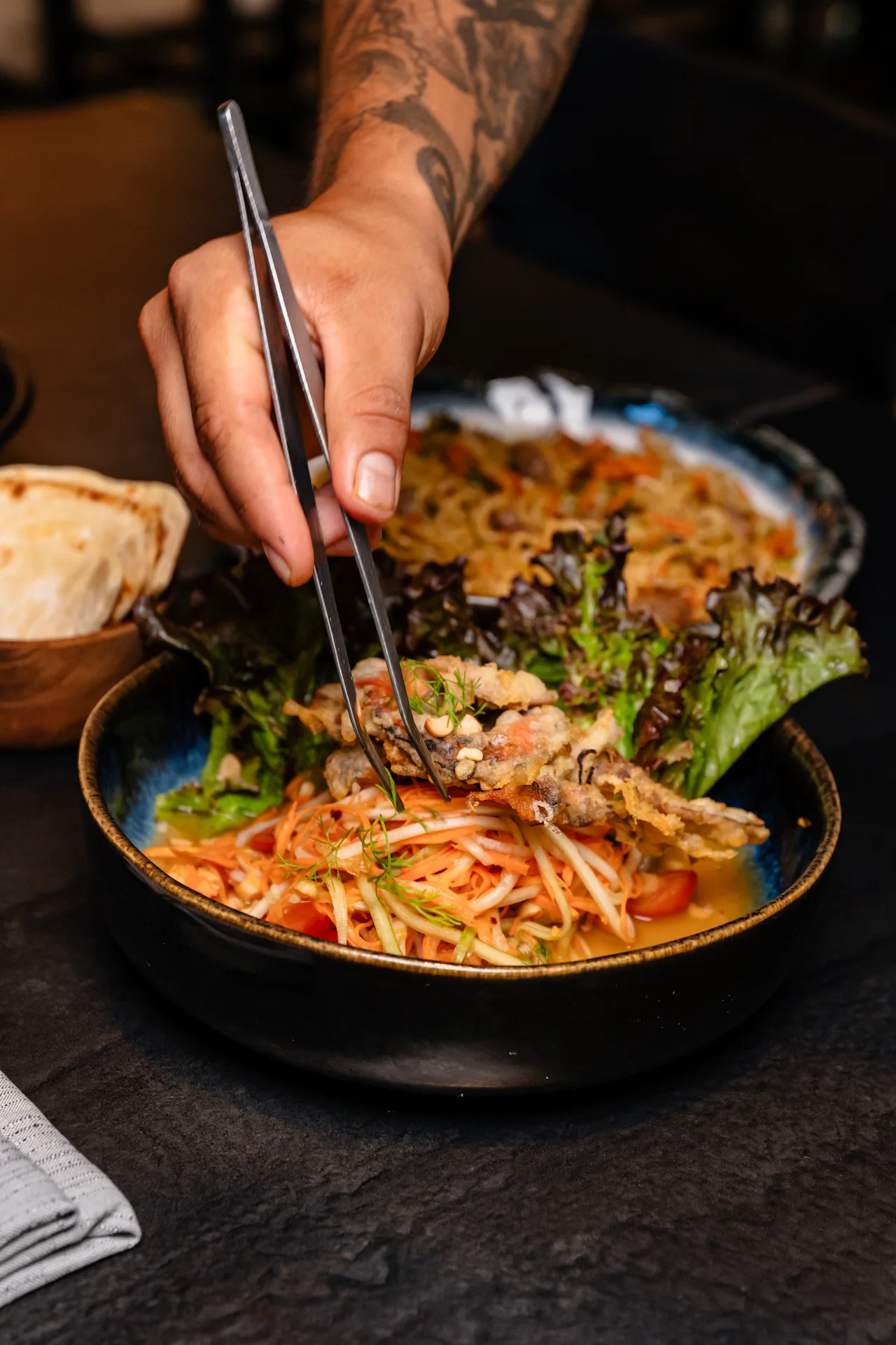 Chef preparing a dish at Kengai restaurant in Conrad Tulum Riviera Maya hotel