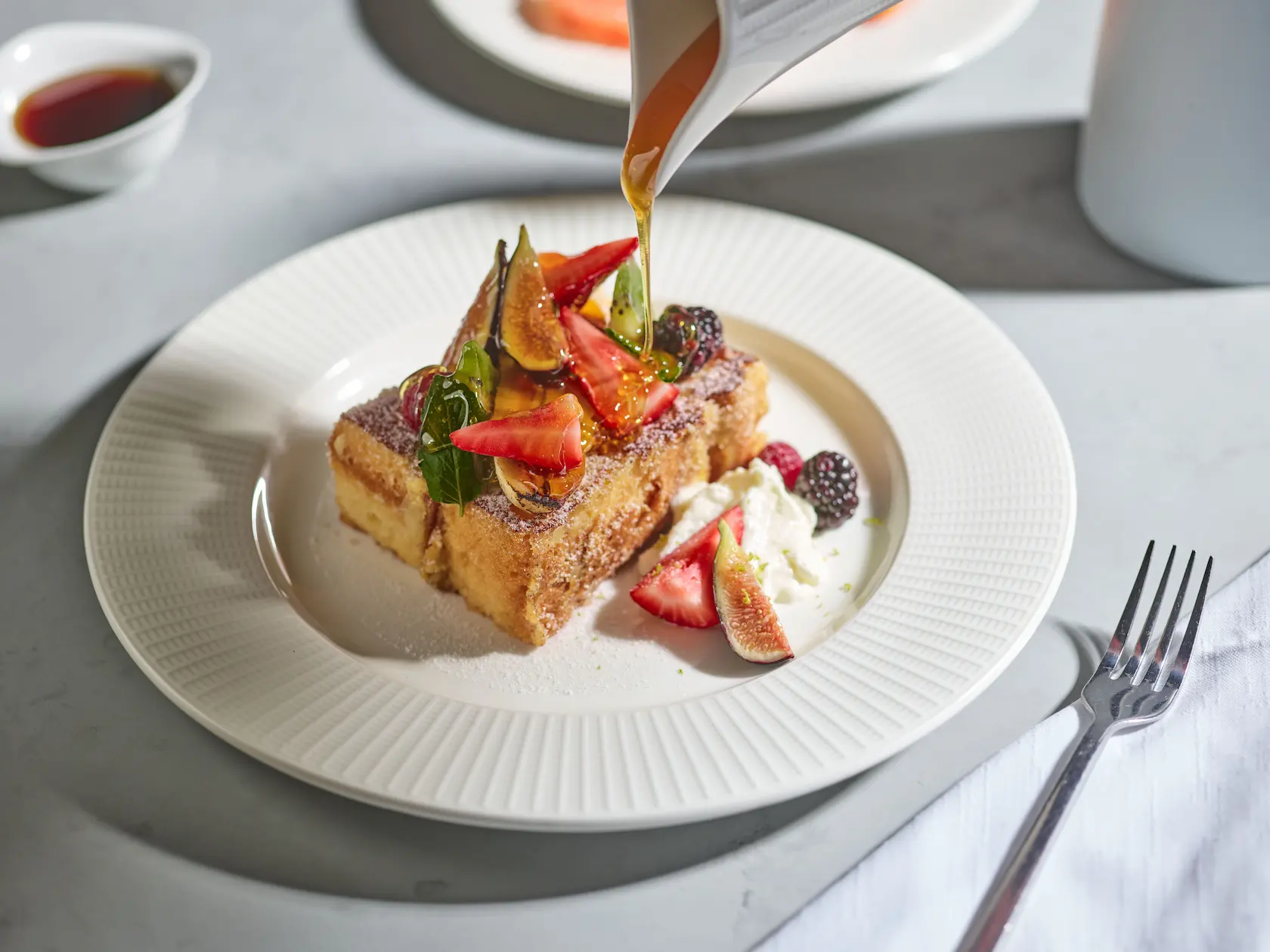 Plate with French toast, a gourmet breakfast option at Conrad Tulum Riviera Maya hotel.