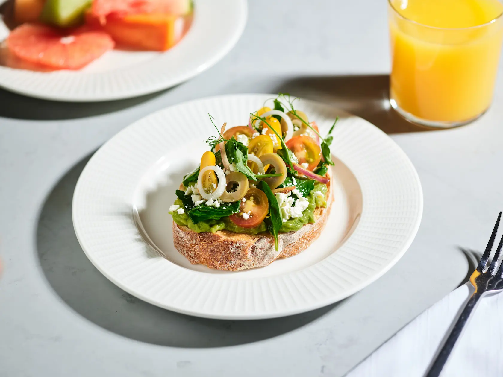 Plate with Mediterranean salad toast, a healthy breakfast option at Conrad Tulum Riviera Maya hotel