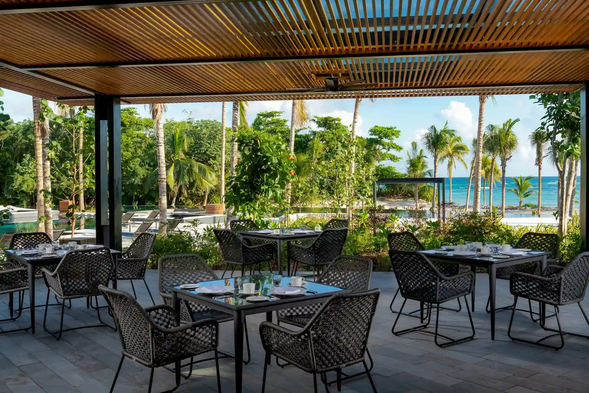 Charming exterior terrace of Arbolea restaurant offering scenic views and comfortable seating