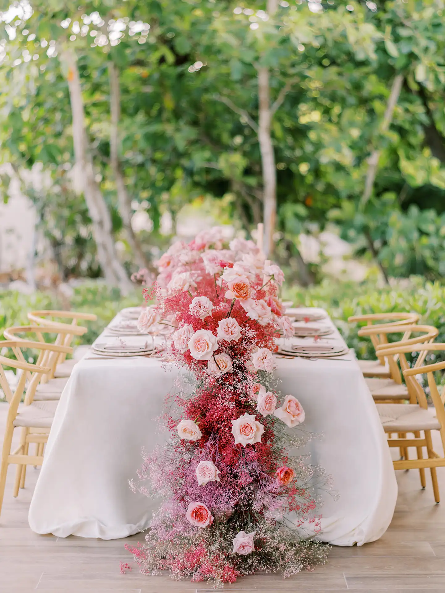 Beautifully decorated wedding table adorned with an abundance of vibrant flowers, creating a romantic and elegant setting at Conrad Tulum