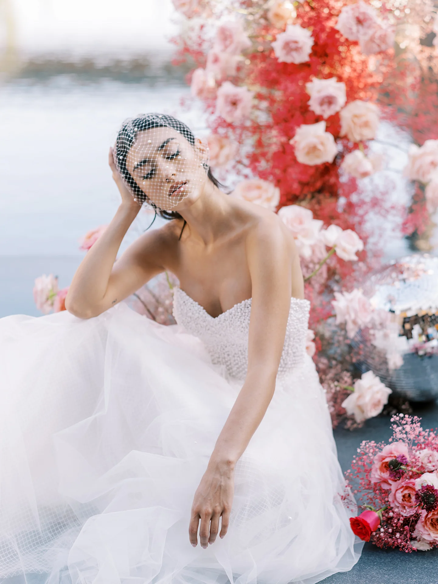 Bride elegantly seated at the altar on her wedding day at Conrad Tulum, surrounded by beautiful decorations and a serene atmosphere