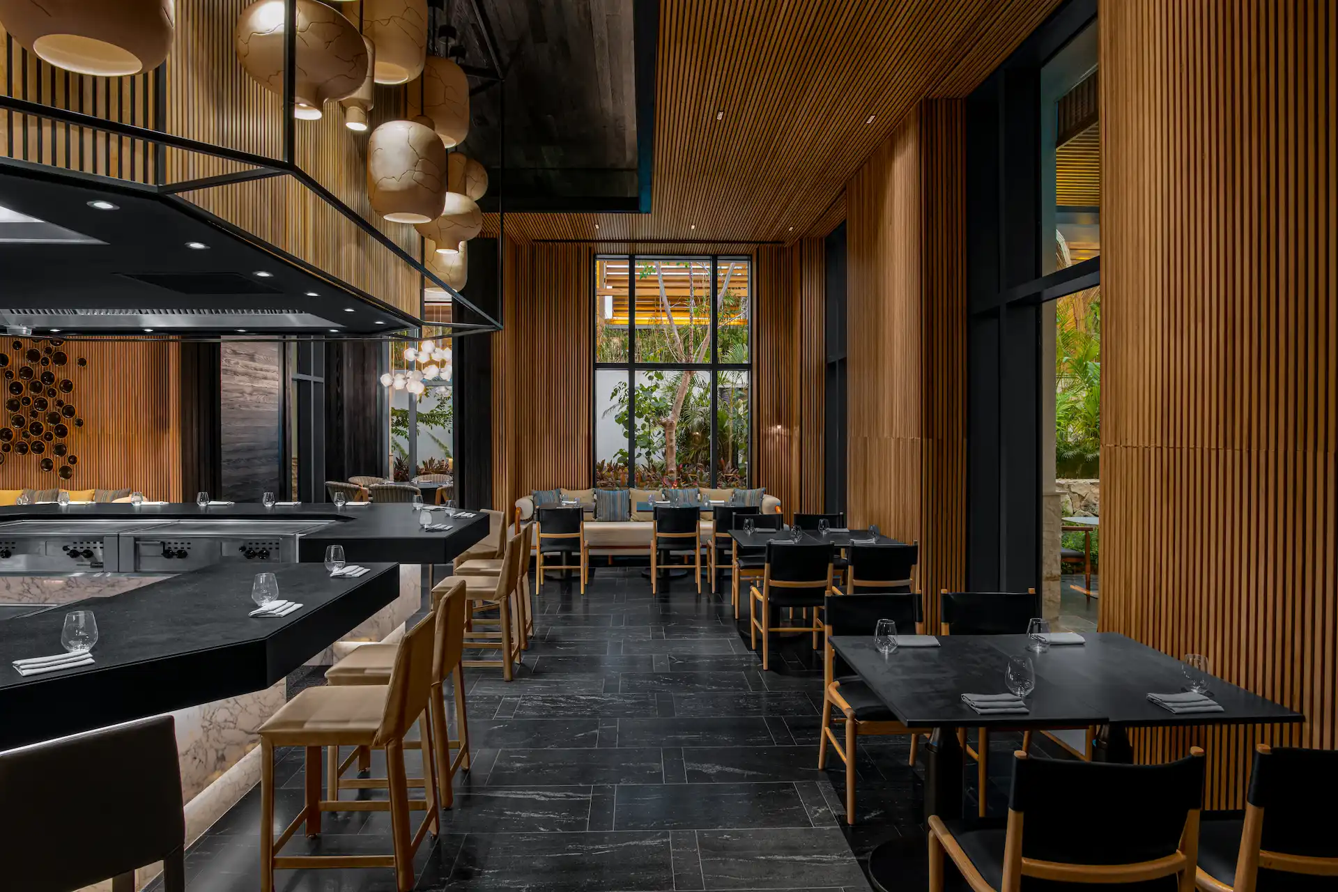 Kengai restaurant interior showcasing a modern design with a bar, tables, and elegant seating arrangement