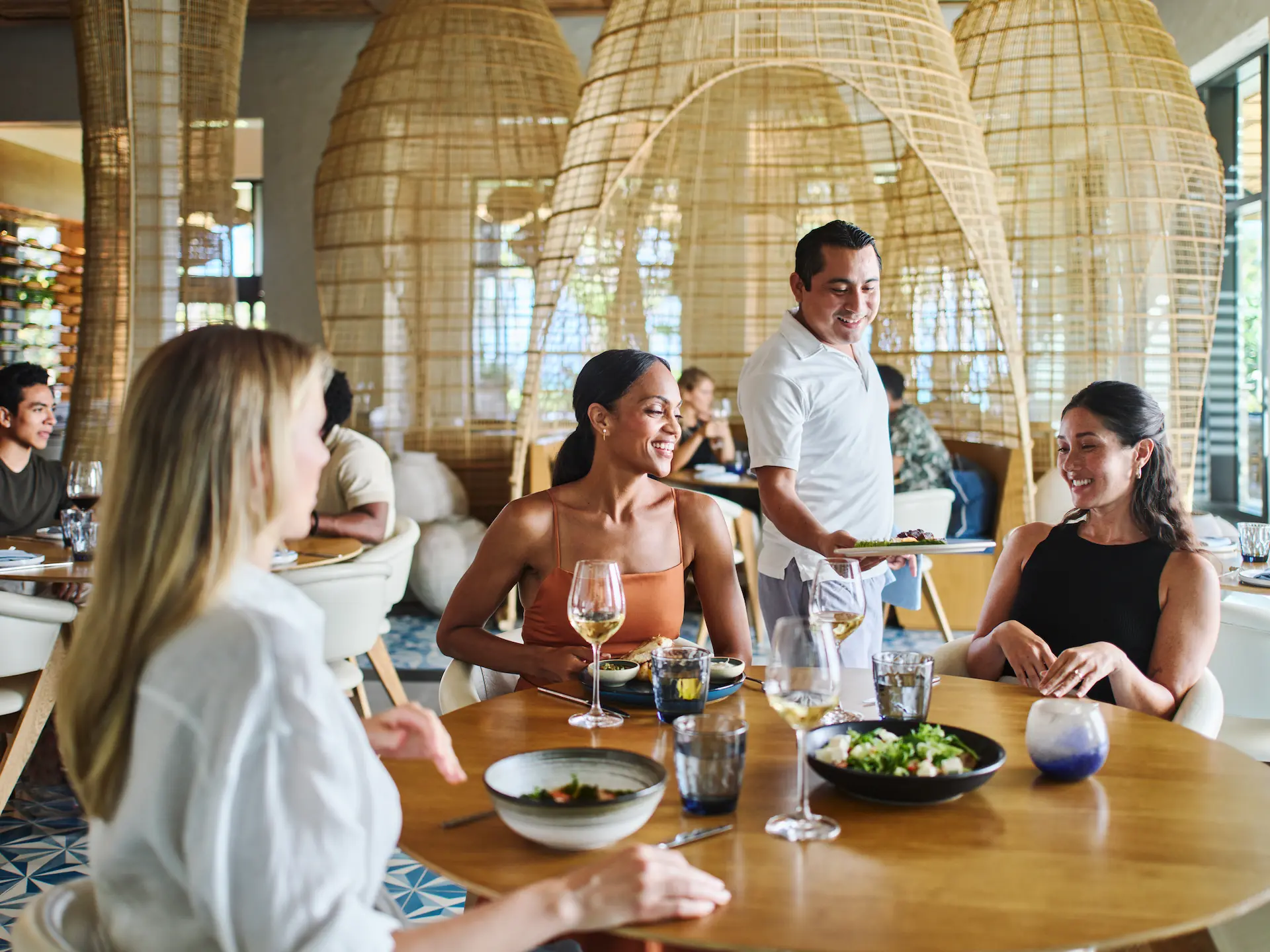 Waiter presenting a delicious meal to guests at Maratea restaurant