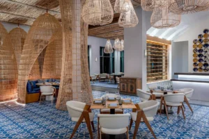 Interior of Maratea restaurant at Conrad Tulum Riviera Maya, featuring Mediterranean-inspired design, bright lighting, and stylish seating