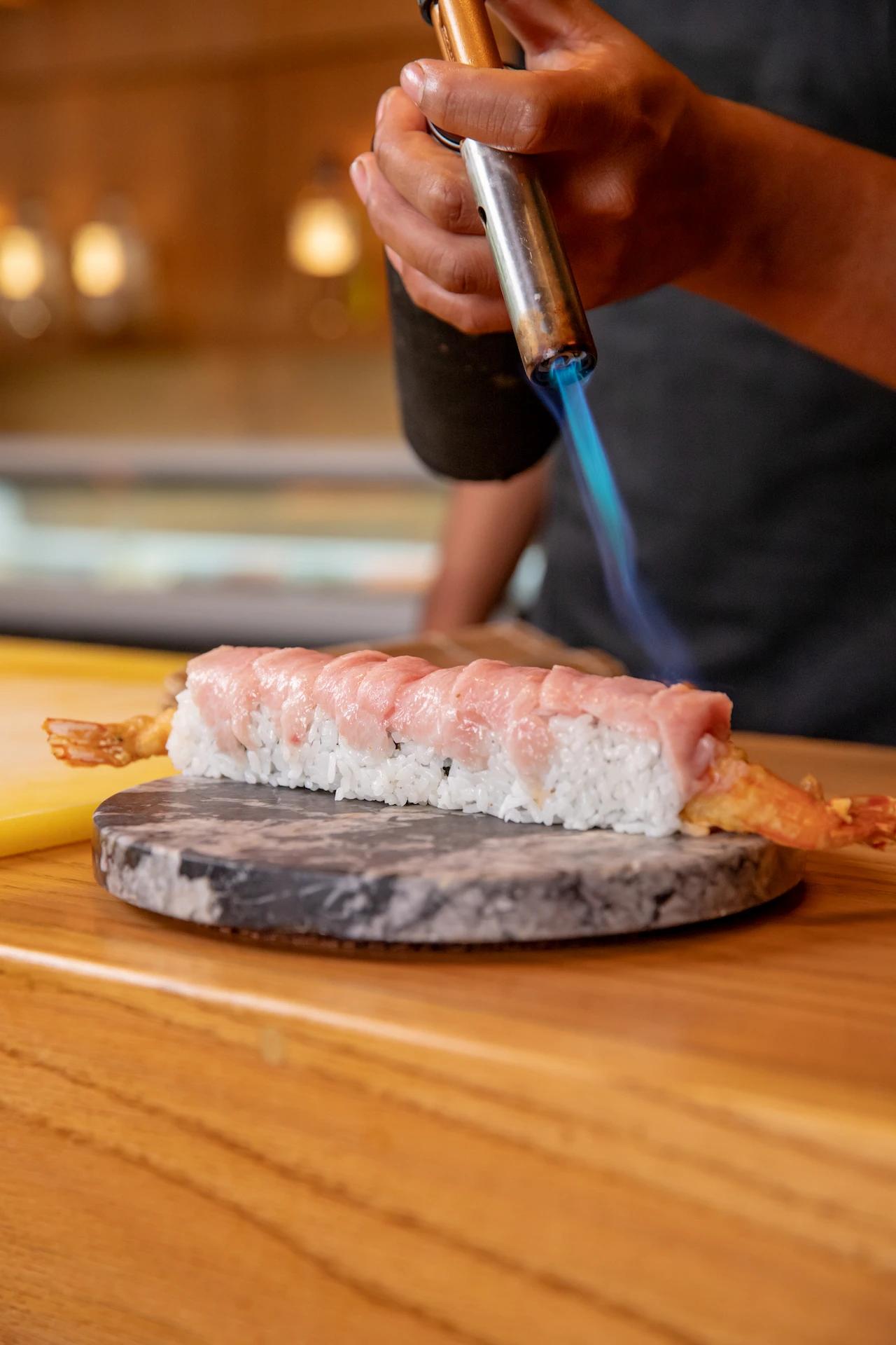 Chef flambéing sushi at Ukai restaurant in Conrad Tulum Riviera Maya hotel