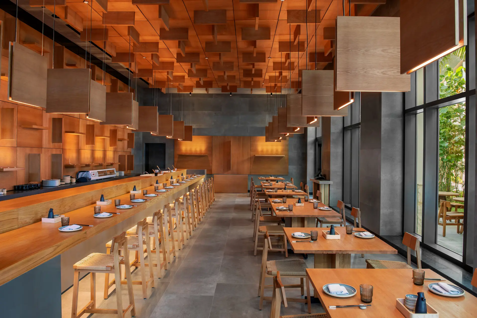 Interior of UKAI restaurant at Conrad Tulum Riviera Maya, showcasing elegant décor and warm lighting