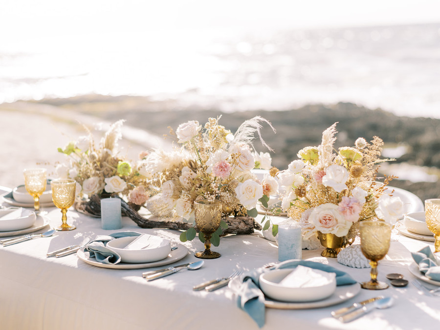 Exquisitely decorated wedding table set with elegant tableware in an outdoor area of Conrad Tulum