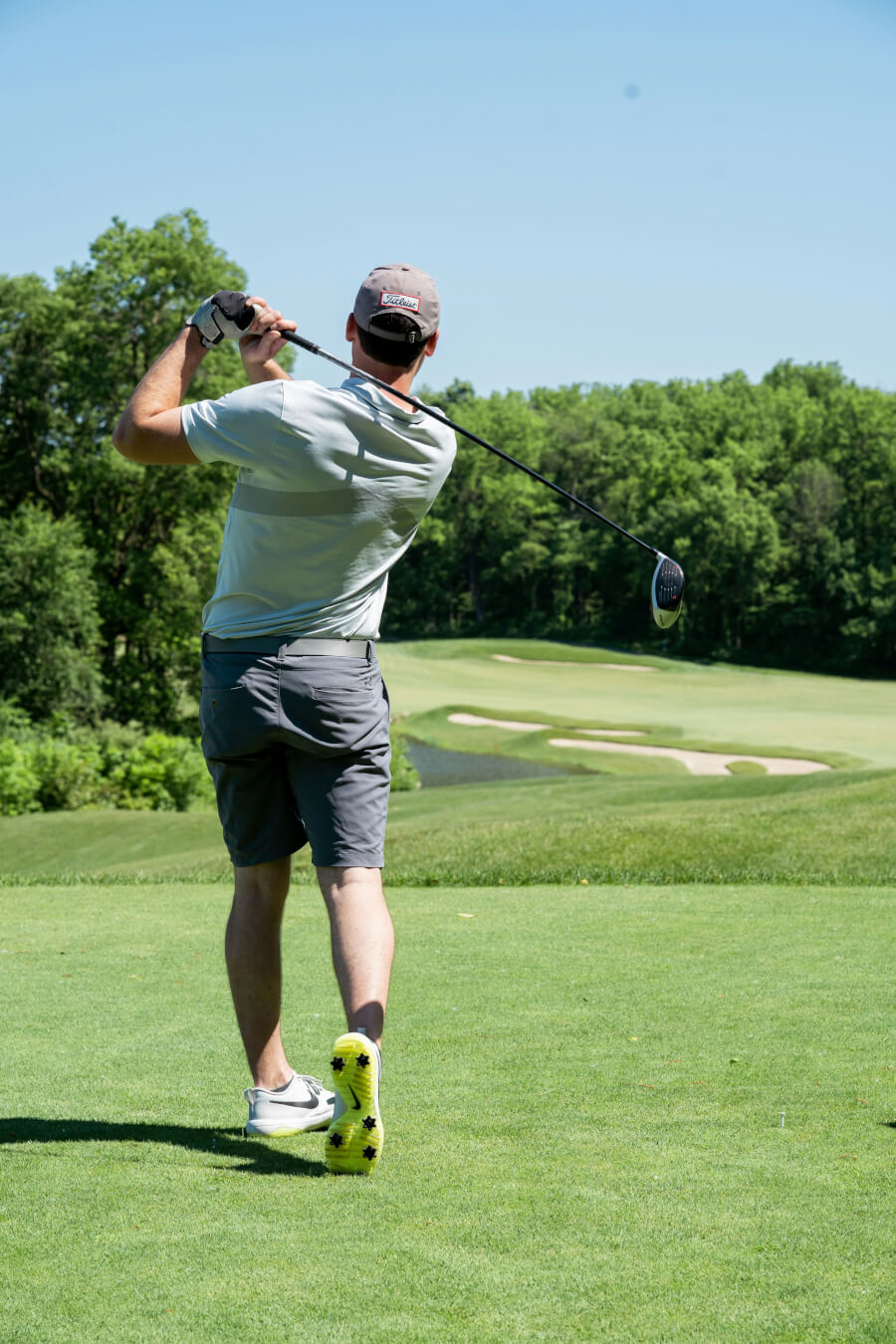 Man playing golf near Conrad Tulum, enjoying the lush greenery and scenic views