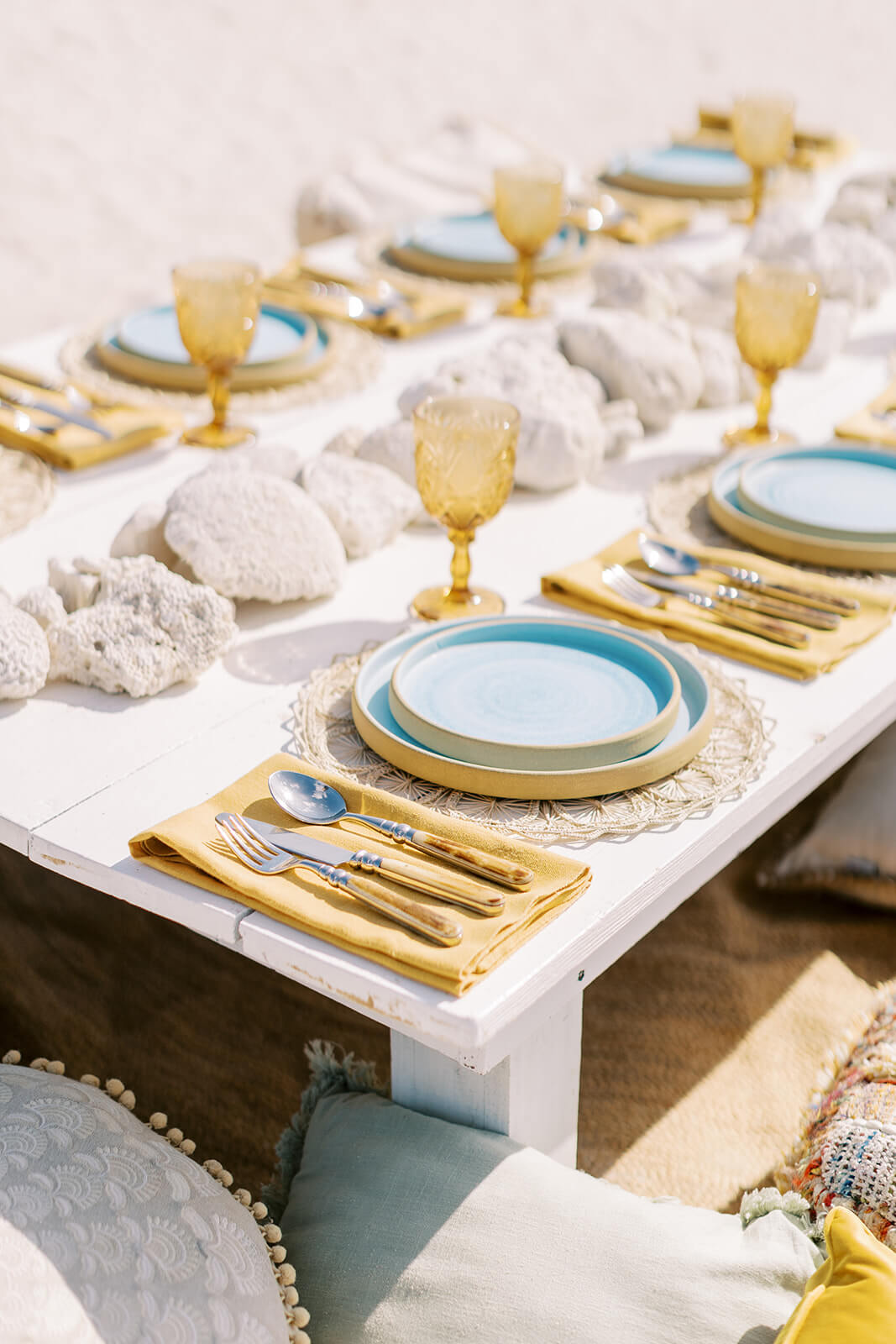 Elegantly set table featuring golden cutlery and exquisite table decor, ready for a special dining experience at Conrad Tulum