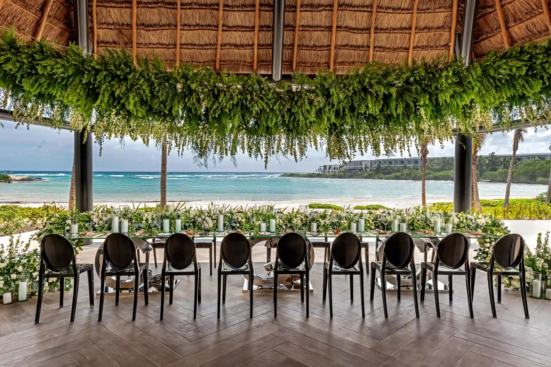 Beautifully decorated wedding table set up on the beach at Conrad Tulum, featuring elegant decor and ocean views