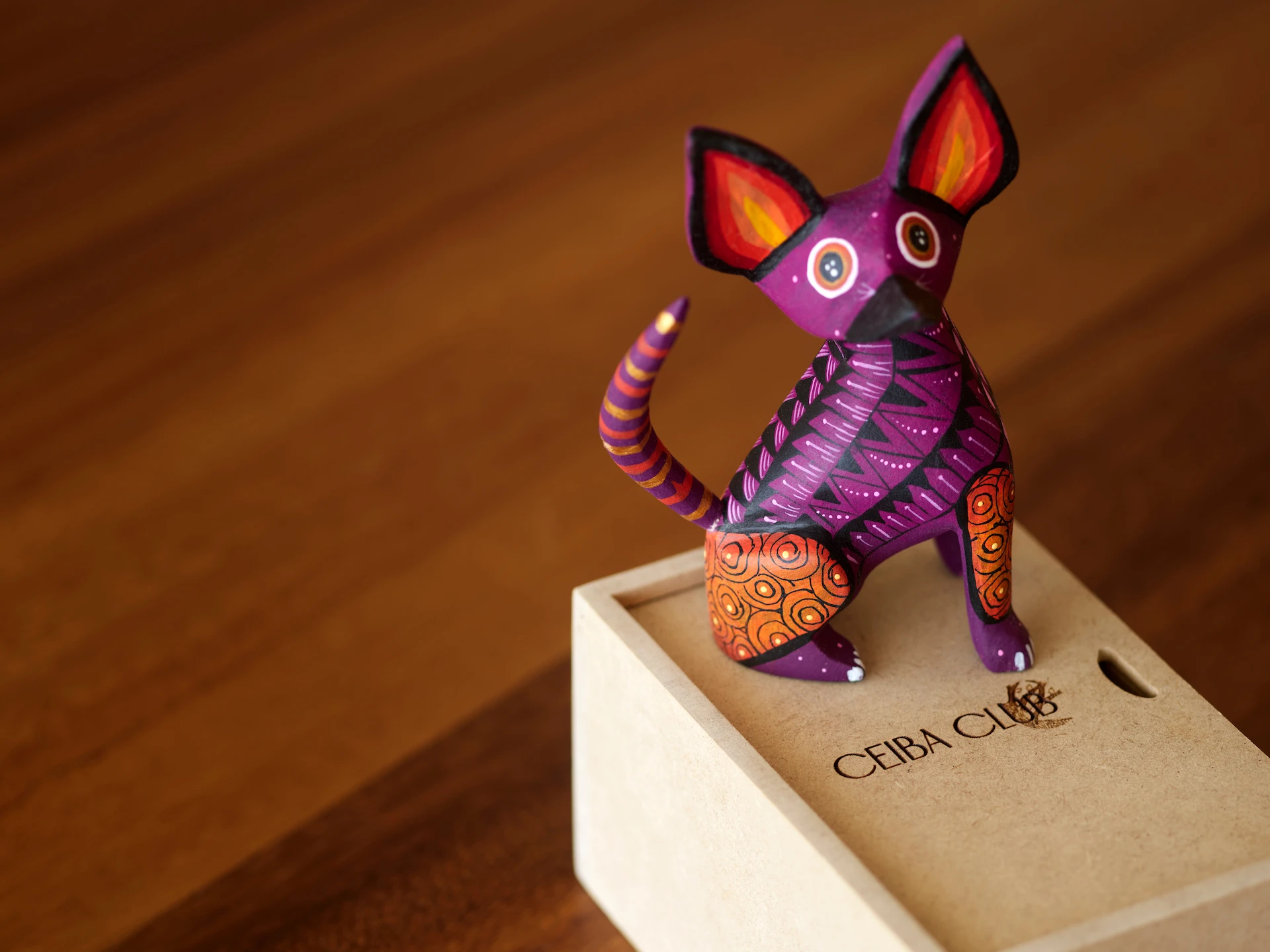 Welcome gift of a hand-carved alebrije, showcasing vibrant colors and intricate details, celebrating Mexican folk art and culture