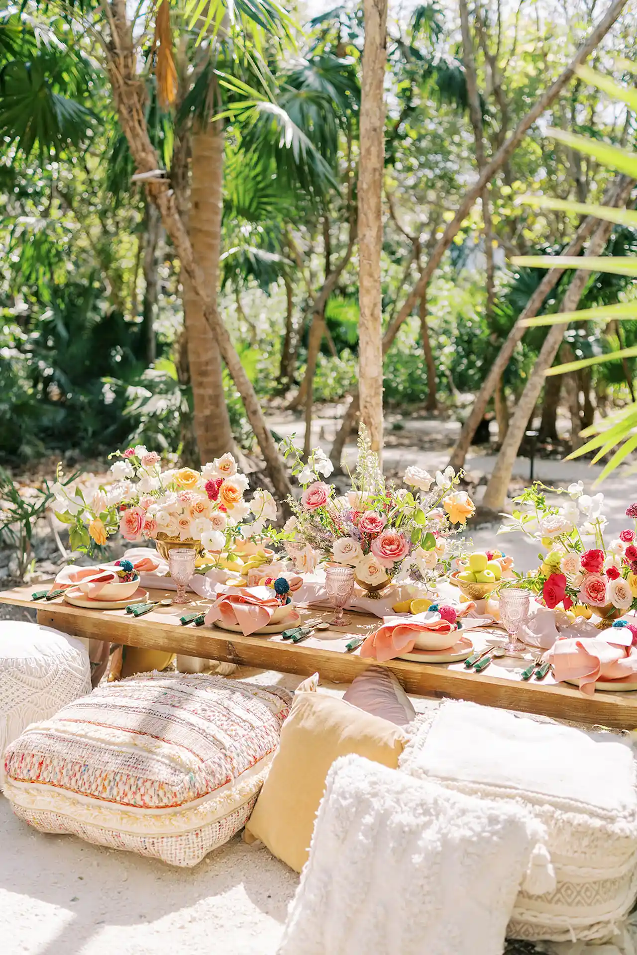 Exquisitely arranged wedding table adorned with fresh flowers at Conrad Tulum, creating a romantic dining atmosphere