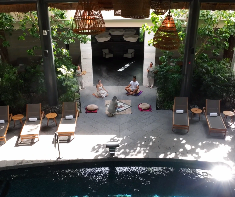 Guests meditating peacefully at the entrance of the spa surrounded by a tranquil atmosphere