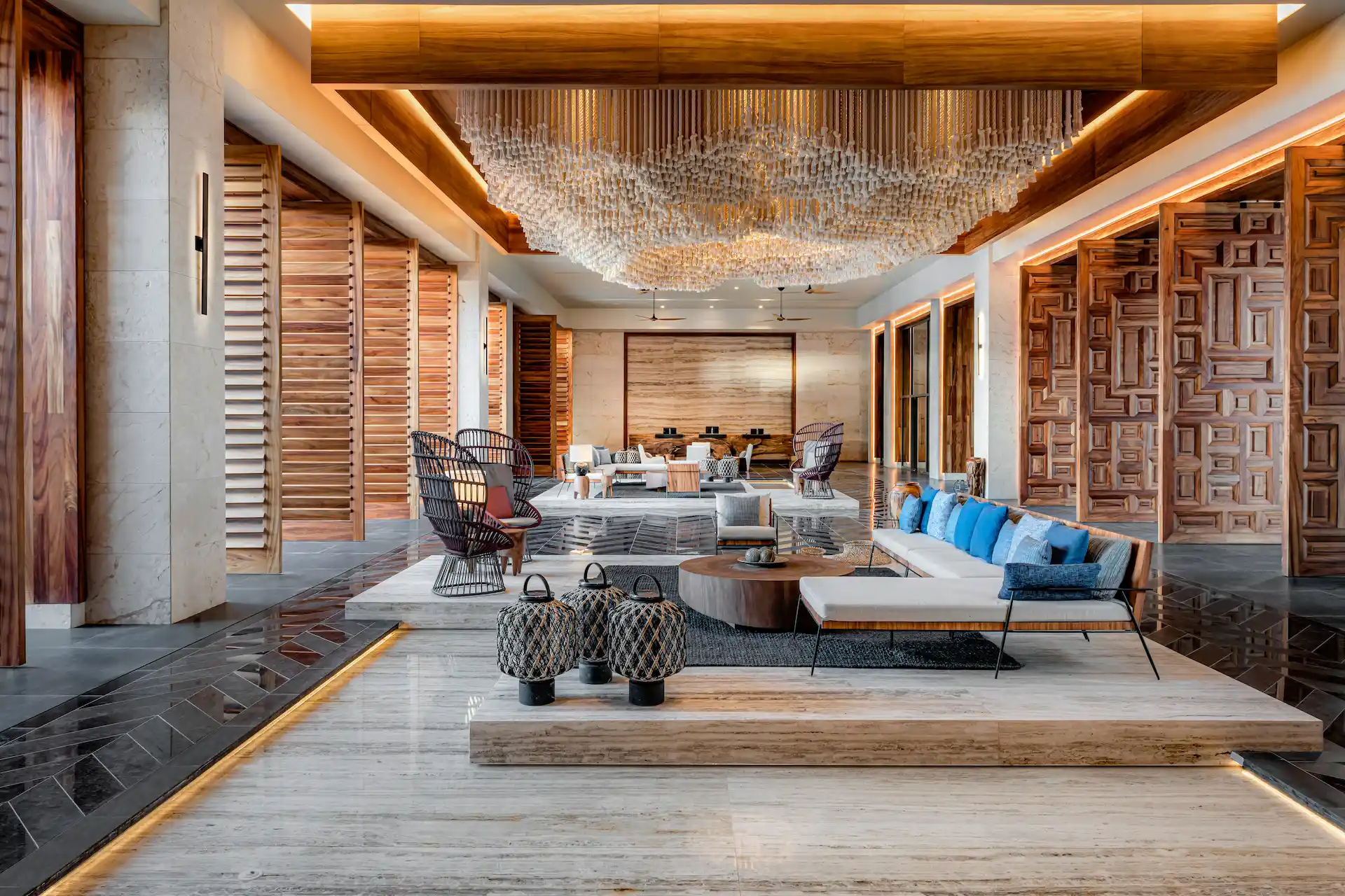 Hotel lobby at Conrad Tulum Riviera Maya featuring modern design, spacious seating, and tropical accents