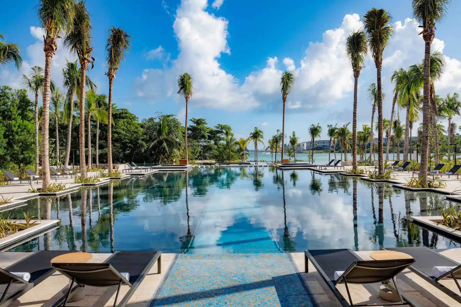 Inviting Ultramar pool at Conrad Tulum, featuring crystal-clear waters and comfortable lounge areas for relaxation