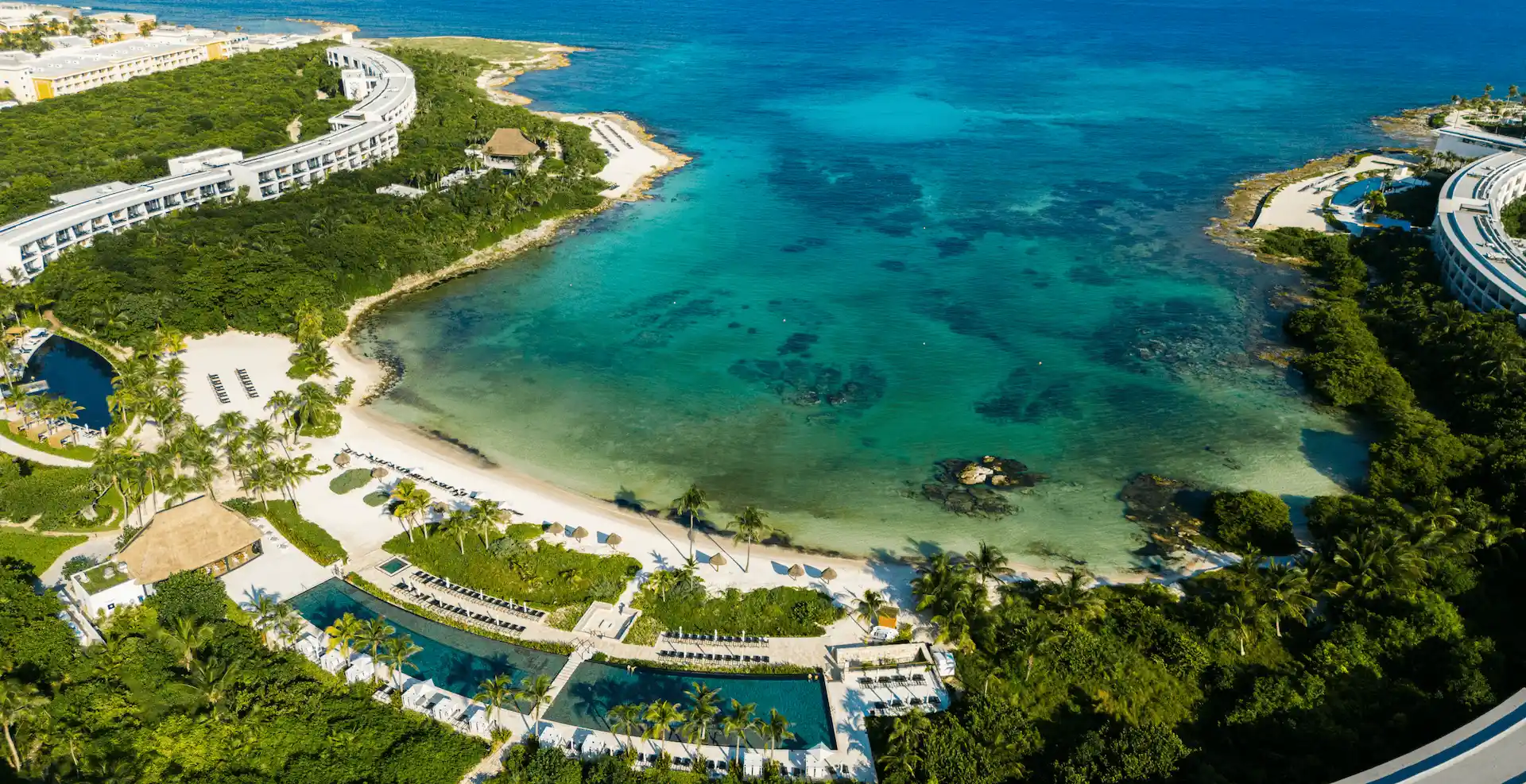 Aerial view of the crystal-clear waters at the private beach of Conrad Tulum Riviera Maya