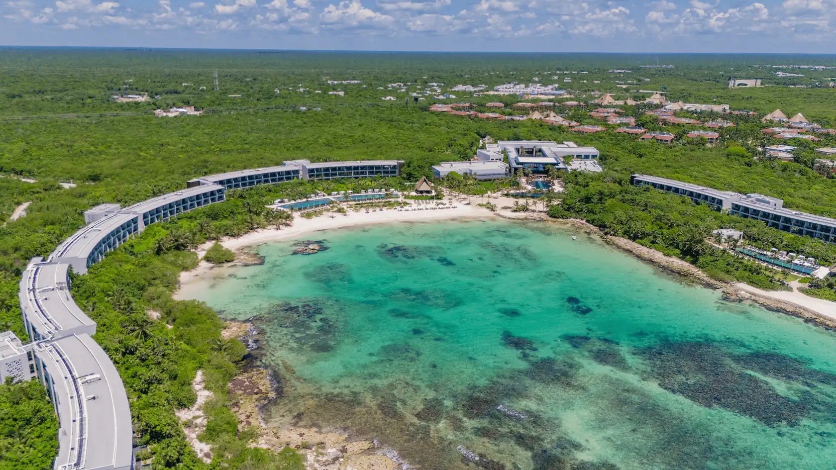 Aerial view of Conrad Tulum Riviera Maya hotel showcasing its architecture and lush surroundings