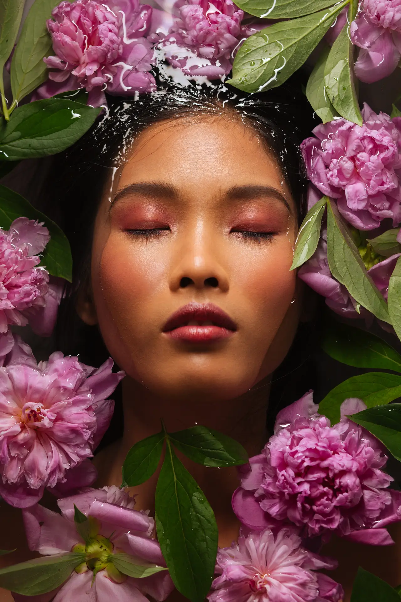 Woman enjoying a flower and water treatment at the spa