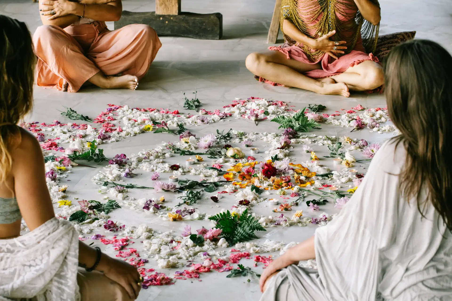 People participating in a floral ritual at the spa of Conrad Tulum Riviera Maya hotel