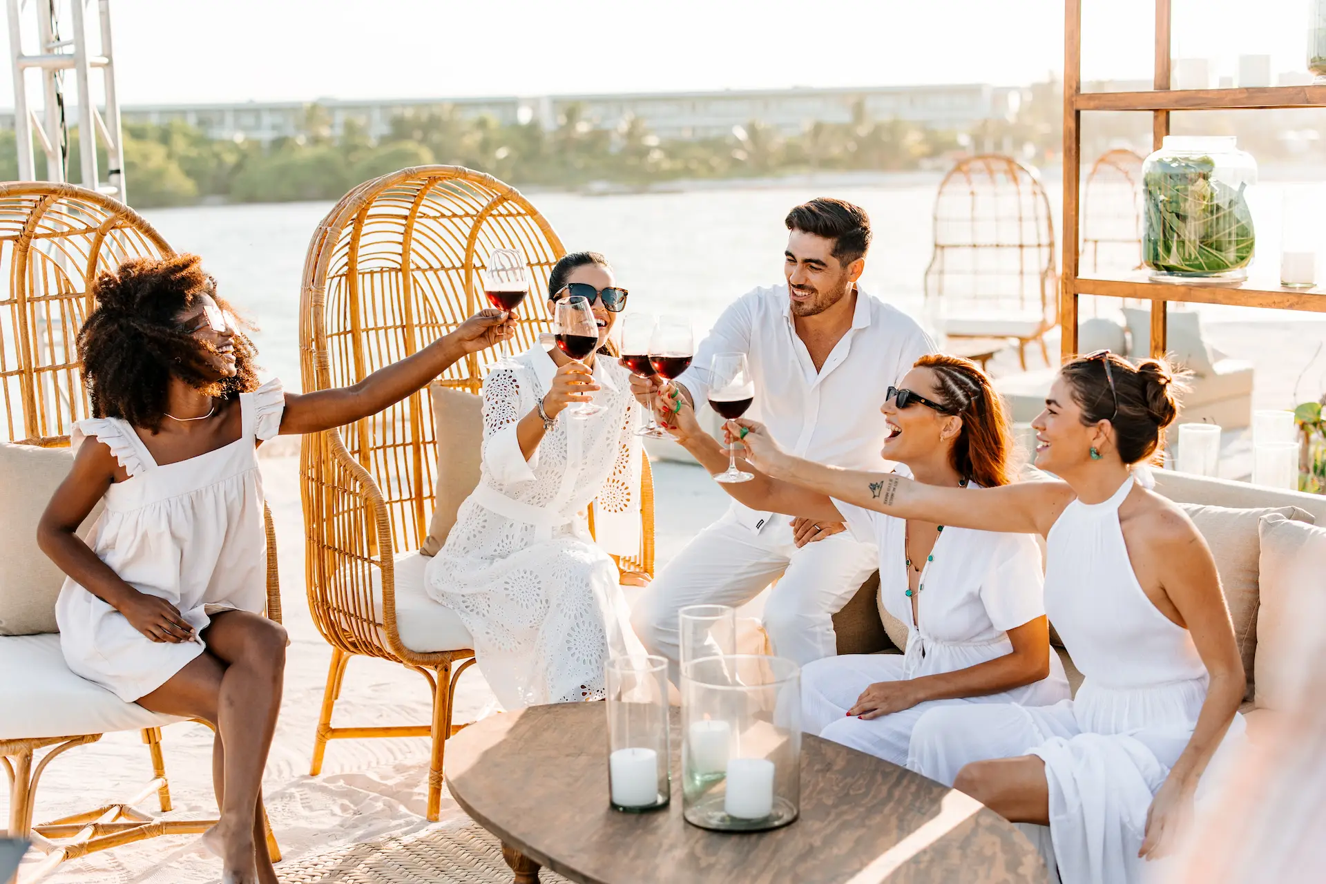 Friends toasting at the White Party event at Conrad Tulum Riviera Maya hotel