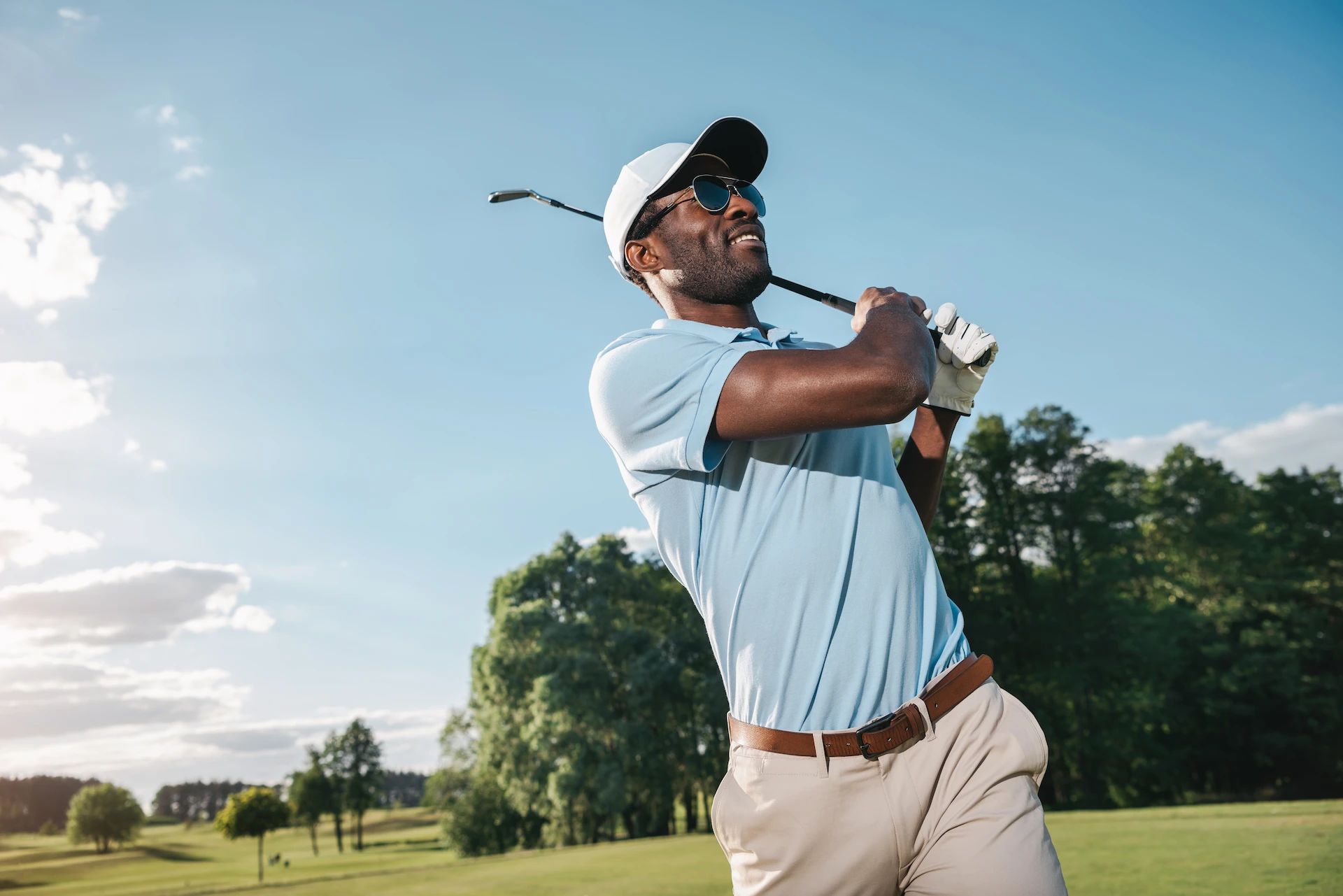 Man playing golf on the course at Conrad Tulum Riviera Maya hotel